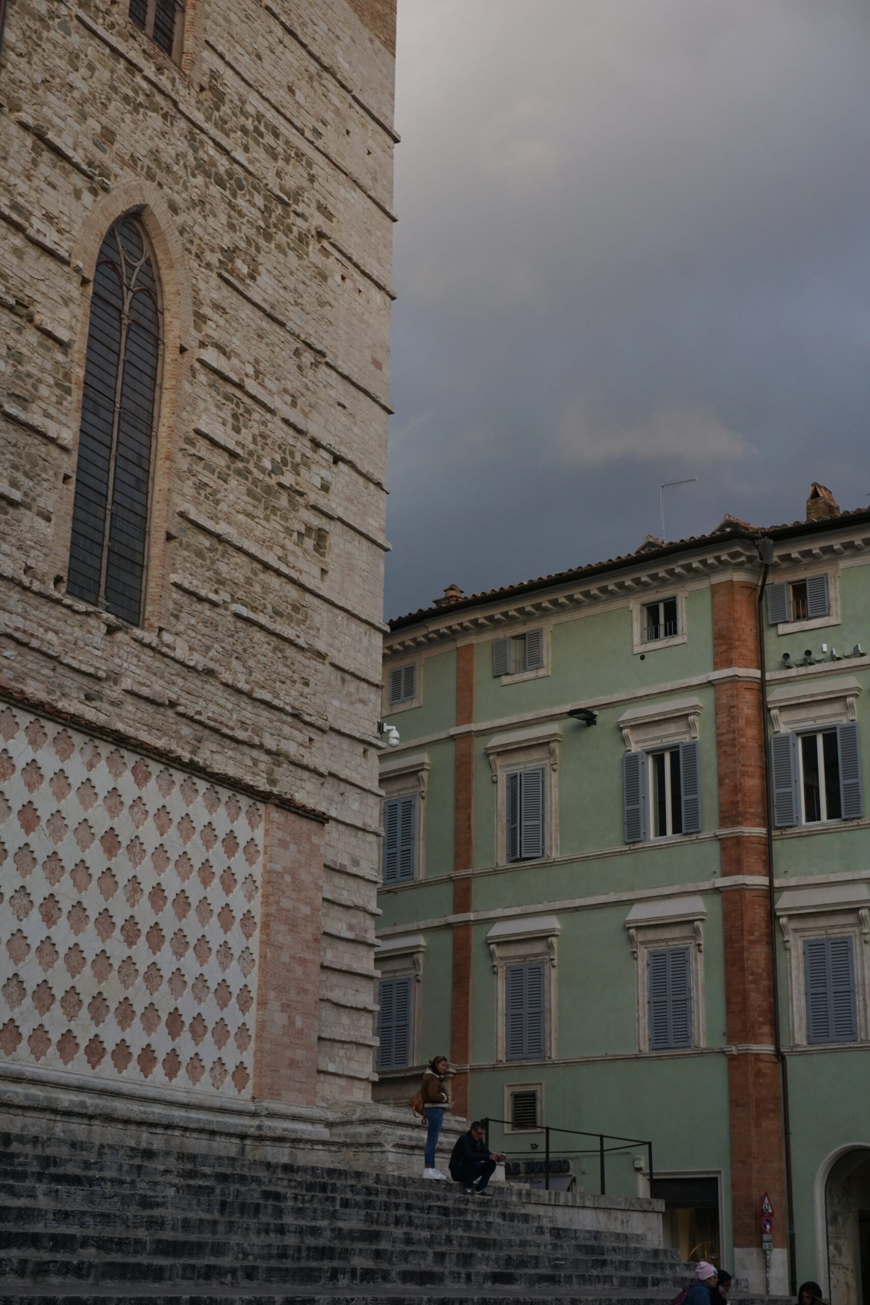 A view of one of the squares in Perugia's old town. It features coloured plaster and tiles.