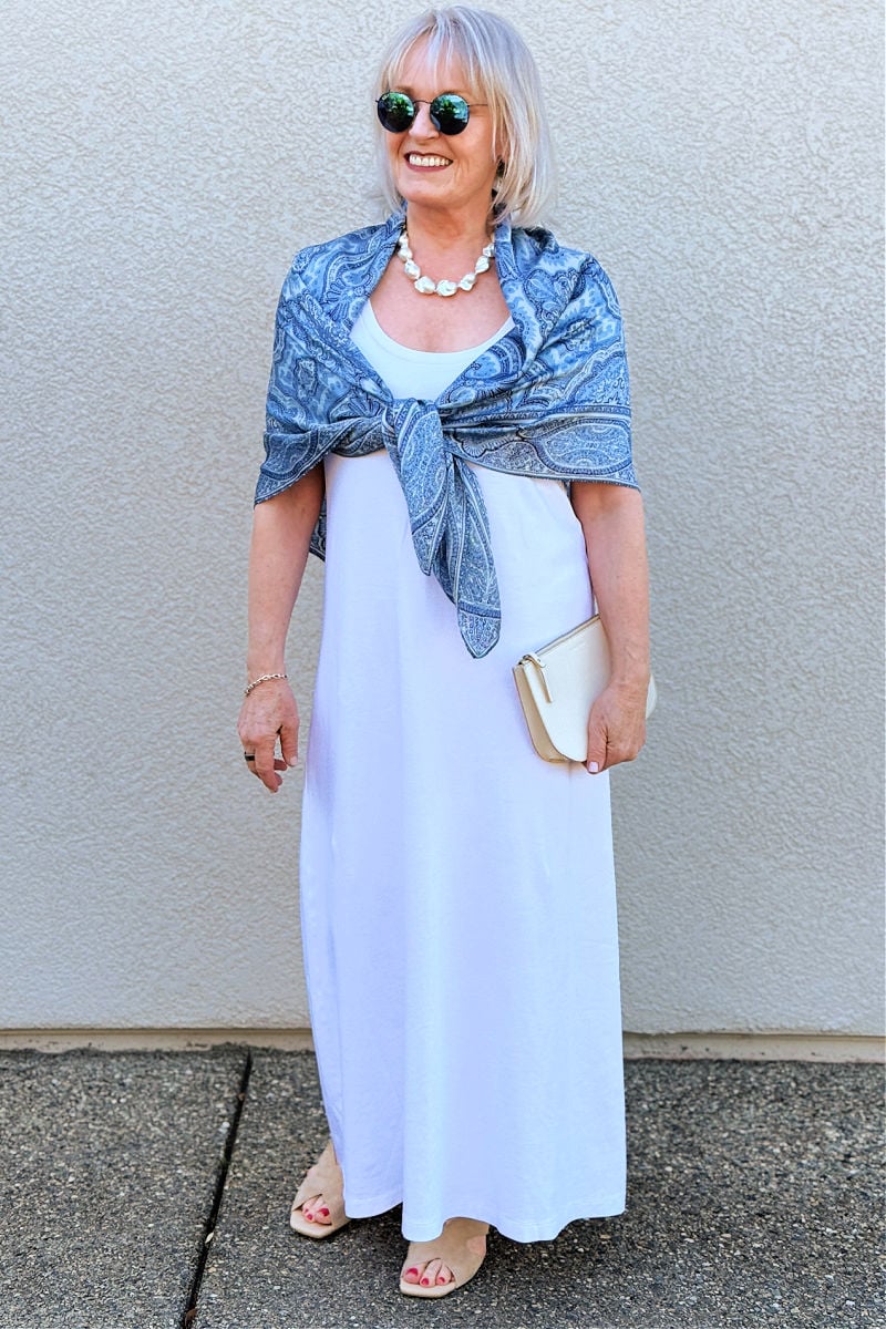 over 60 woman showing What to wear abroad with casual dress and supportive sandals