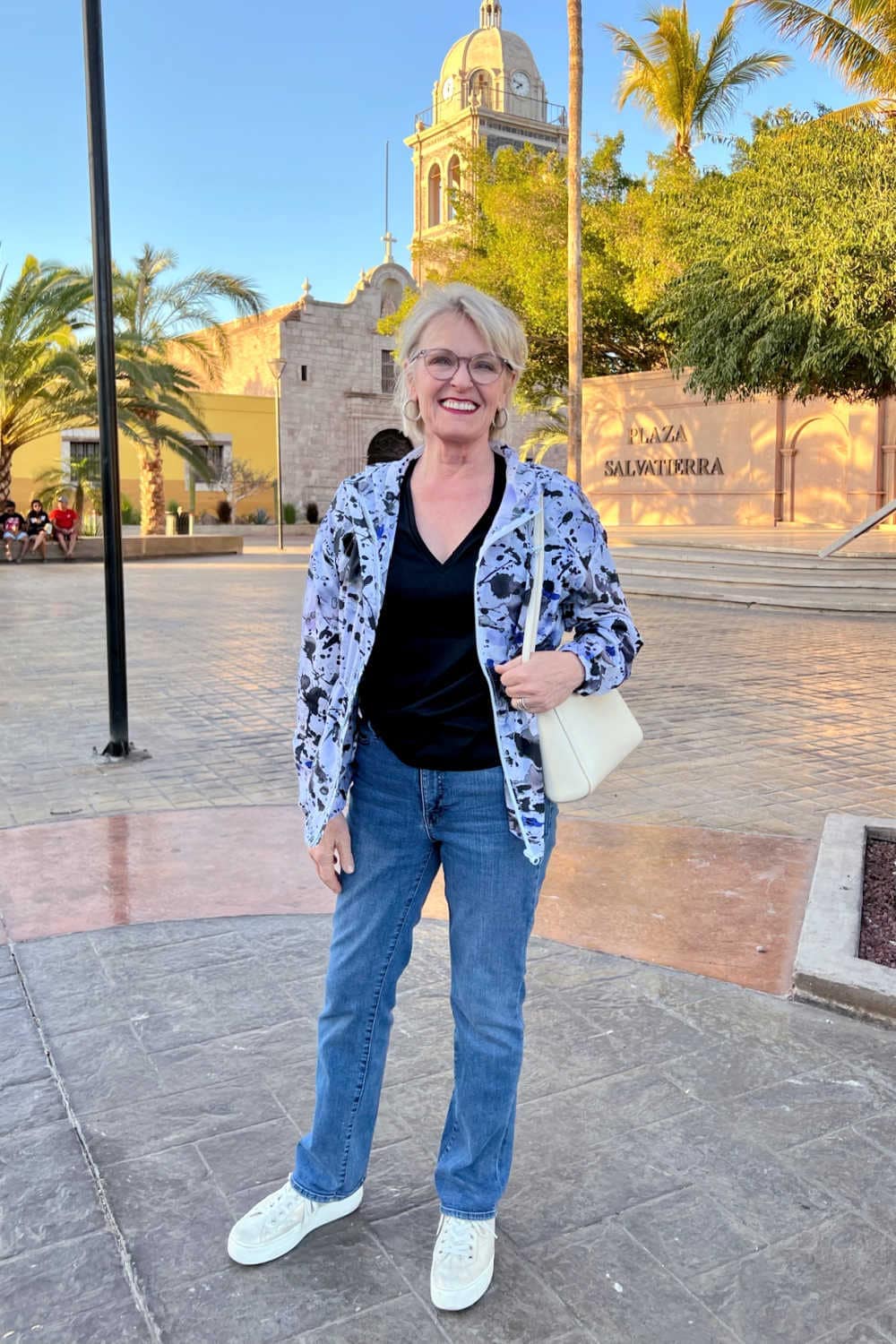 older woman wearing Minimalist jewelry and travel accessories