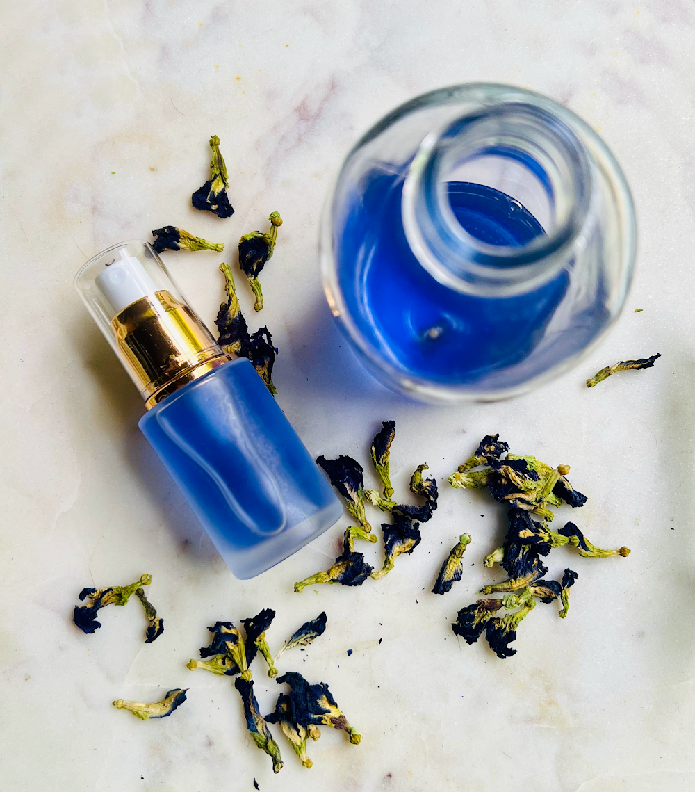 2 glass bottles with butterfly pea toner