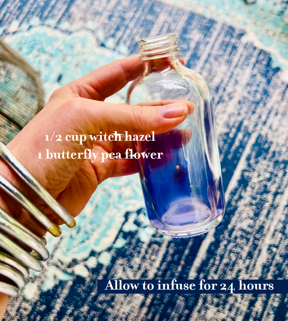 Hand holding butterfly pea toner.