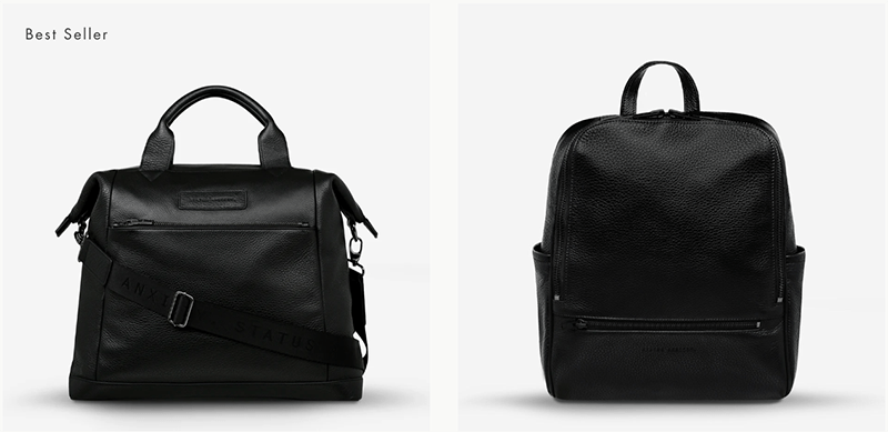 A stylish black leather backpack with a sleek design, featuring a front zip pocket and dual carry options, sitting beside a minimalist black leather handbag with a strap.