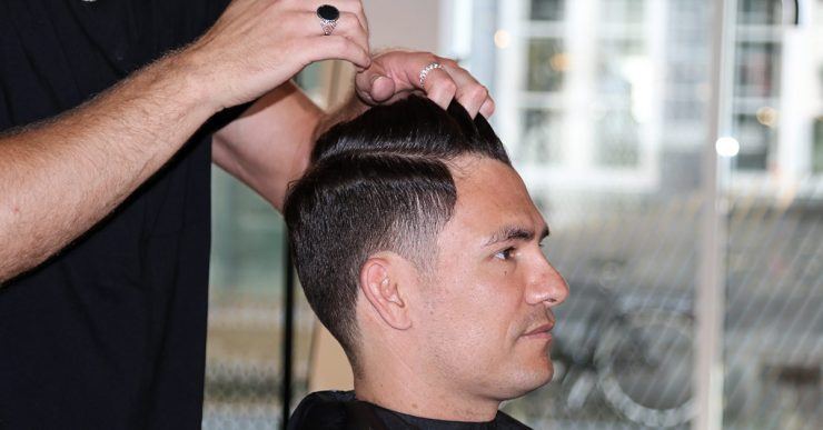 Man getting his hair styled by the hairdresser